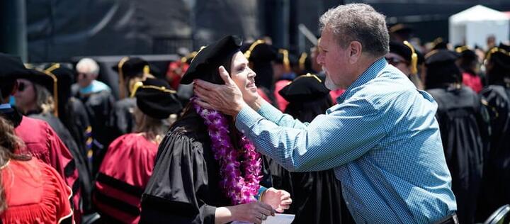 a father showing his pride his daughters graduation